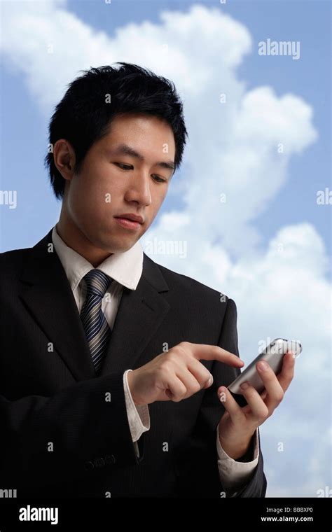 Businessman Using Hand Held Device Stock Photo Alamy