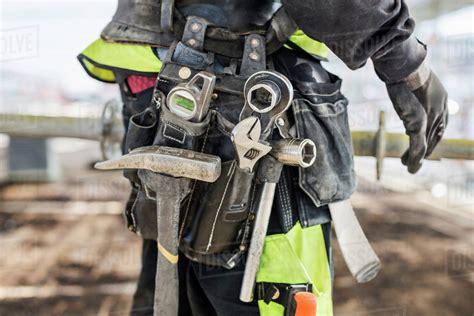 Midsection Of Construction Worker Wearing Tool Belt At Site Stock