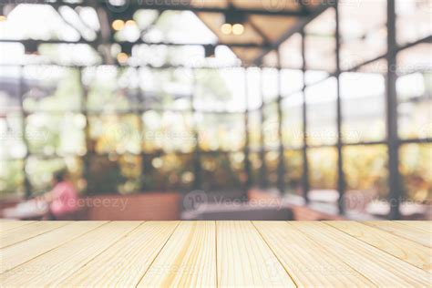 Empty Wooden Table Top With Cafe Restaurant Coffee Shop Interior