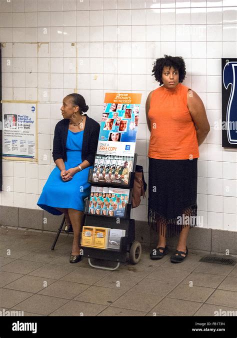 African American Jehovahs Witnesses Accompany An Information Display