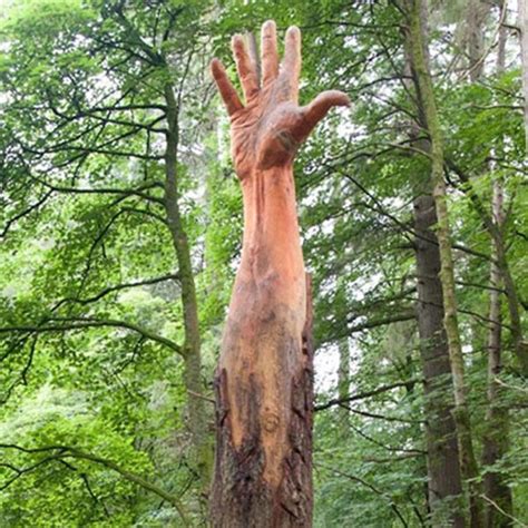 Artist Uses A Chainsaw To Transform A Damaged Tree Into A Giant Hand