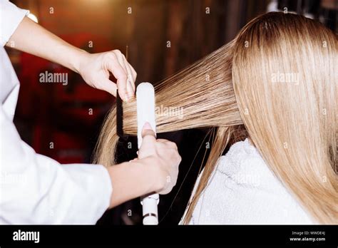 Close Up Of Process Straightening Long Blonde Hair With Hair Irons Beauty Hairstyle Hot