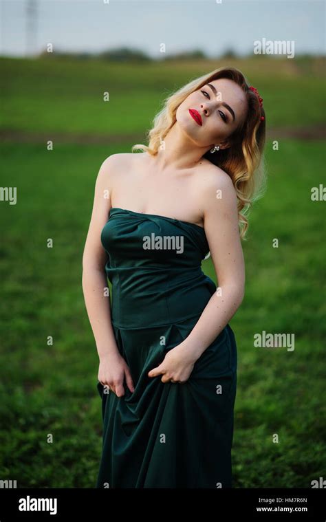 Yong Elegance Blonde Girl At Green Dress On The Garden In Spring Stock