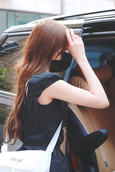 A Woman Leaning On The Door Of A Car And Holding Her Hand To Her Face