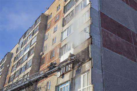 A Firefighter Extinguishes A Balcony In A High Rise Building From A