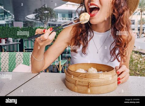 Girl With Chopsticks Eating Delicious Traditional Chinese Delicacy Xiaolongbao Dumplings Or