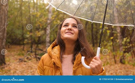 Portrait Of A Pretty Woman Holding An Umbrella Under The Rain In An