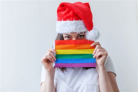 Premium Photo Beautiful Lesbian Girl In Red Santa Claus Hat With Lgbt Rainbow Flag Isolated