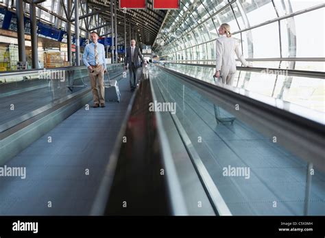 Germany, Leipzig-Halle, Airport, Business people on travelator Stock Photo - Alamy