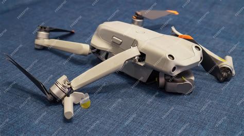 Premium Photo | Broken drone after a fall with torn cables and a broken ...