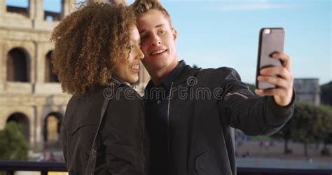 Happy Multiethnic Couple Take A Selfie In Front Of Coliseum Stock Video