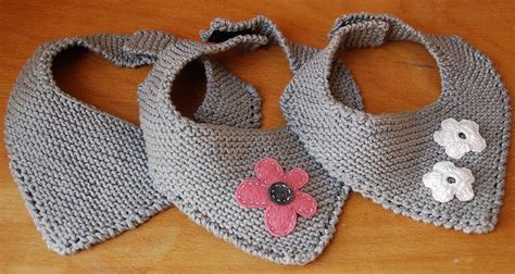 Two Crocheted Baby Shoes With Flowers On Them