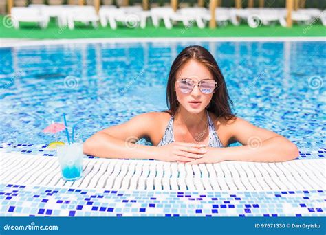 Portrait Of Beautiful Young Woman In Sunglasses With Cocktail In