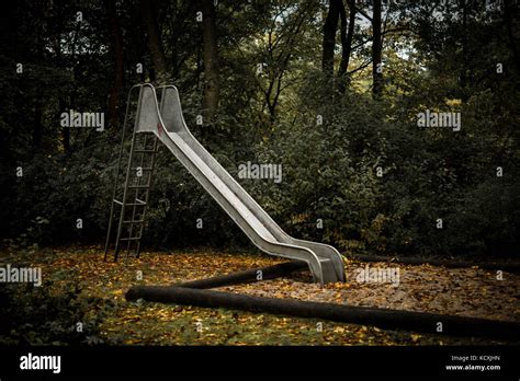 Old abandoned playground with slide in autumn Stock Photo - Alamy