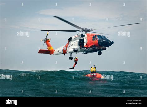 A US Coast Guard Rescue swimmers are deployed from a MH-60 Jayhawk ...