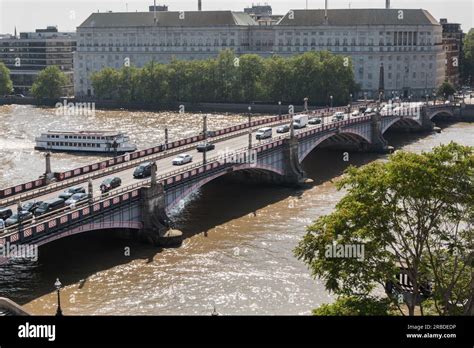 Southbound Traffic Passing Across Lambeth Bridge With Thames House Mi5