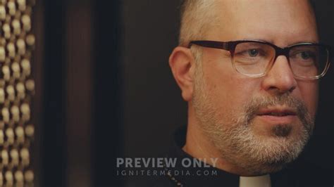 Mature Catholic Priest Sitting In Confessional And Giving Advice To Senior Woman During
