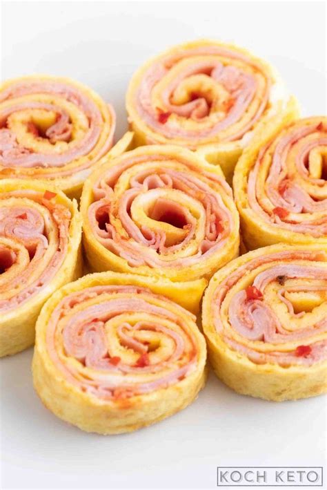 Several Rolls With Ham And Cheese Are Arranged On A White Plate Ready