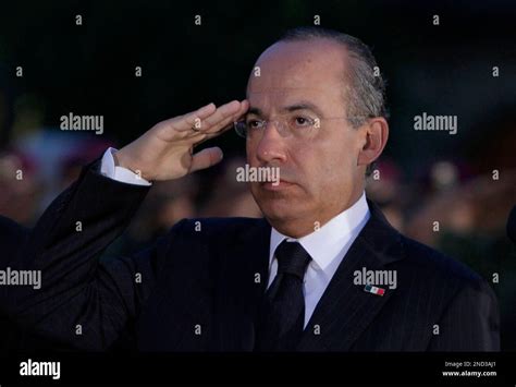 Mexico S President Felipe Calderon Salutes During A Ceremony To Mark