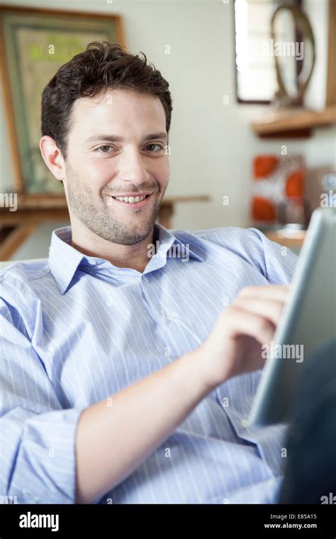 Man Using Digital Tablet Smiling At Camera Stock Photo Alamy