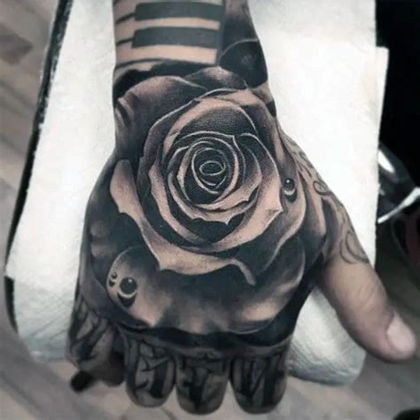 detailed-mens-hand-tattoo-of-black-ink-rose-flower-with-water-droplet – Lazy Penguins