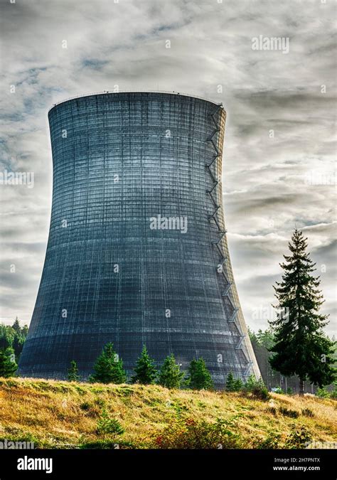 A Dramatic Sky Stands Behind One Of The Cooling Towers At The