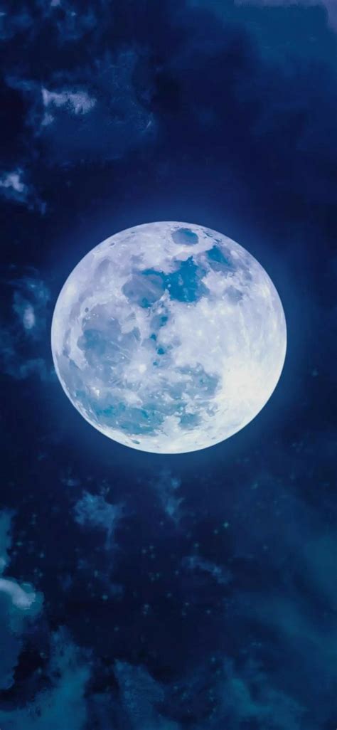 The Full Moon Is Shining Brightly In The Night Sky With Clouds And Blue