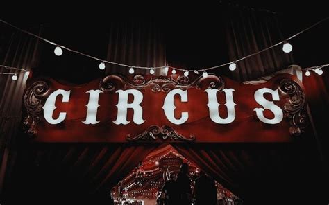 There Is A Sign That Says Circus On The Side Of The Building With Lights Around It