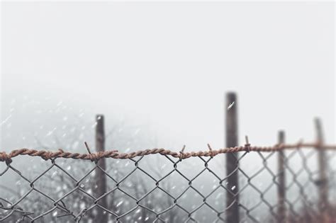 Premium Ai Image A Fence Around A Gated Area With Barbed Wire Against