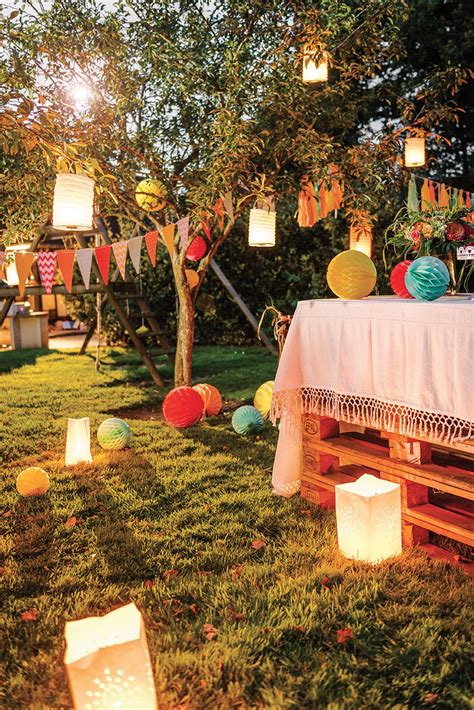 An Outdoor Party With Lanterns And Paper Lanterns On The Grass In