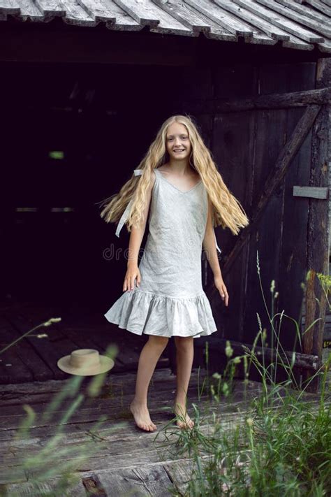 Portrait Of A Beautiful Village Girl Blonde With Long Hair In A Dress