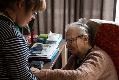 85 Yo Senior Woman Taking Care Of Her 40 Yo Daughter With The Down