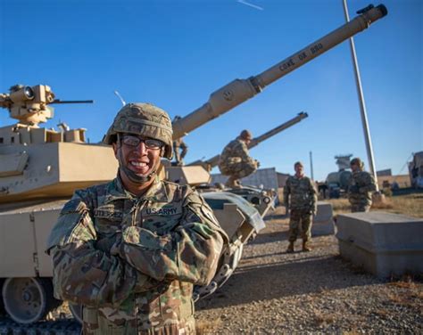 Us Army Pfc Oj Gutierrez Stands In Front Of An M1a1 Abrams Tank At