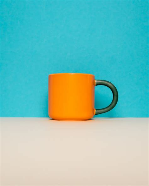 A Coffee Cup Sitting On Top Of A Table Photo Free Coffee Cup Image On