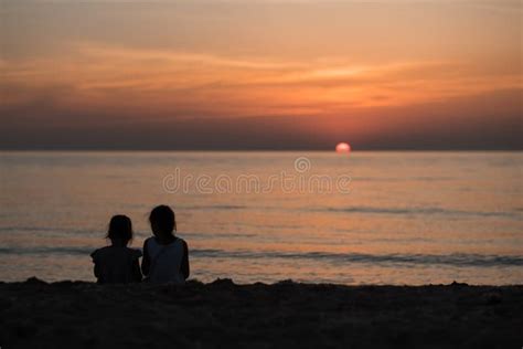 Two European Girls Enjoy The Sunset On The Sea Play Hug Smile Love