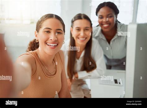 Portrait Of A Confident Young Hispanic Business Woman Taking Selfies