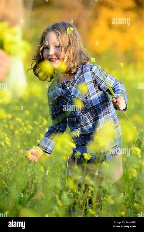 Girl picking flowers Stock Photo - Alamy