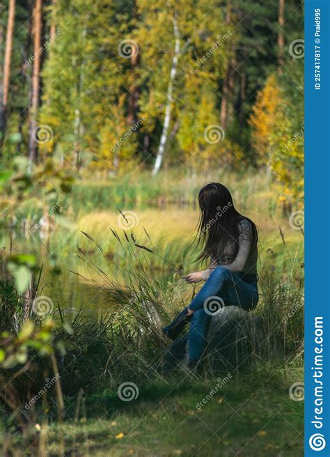 A Girl Sits In The Forest On A Stone With Her Hair Down Stock Image Image Of Turning Girl