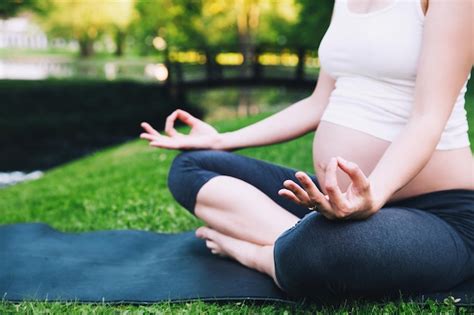 Premium Photo Closeup Of Pregnant Woman Meditating While Sitting In