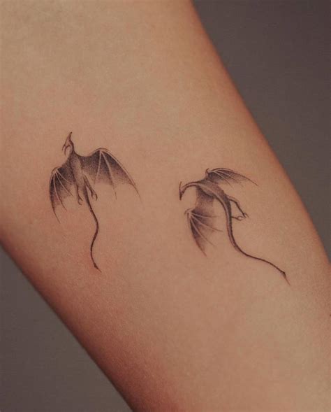 Tiny Dragons Tattooed On The Inner Arm