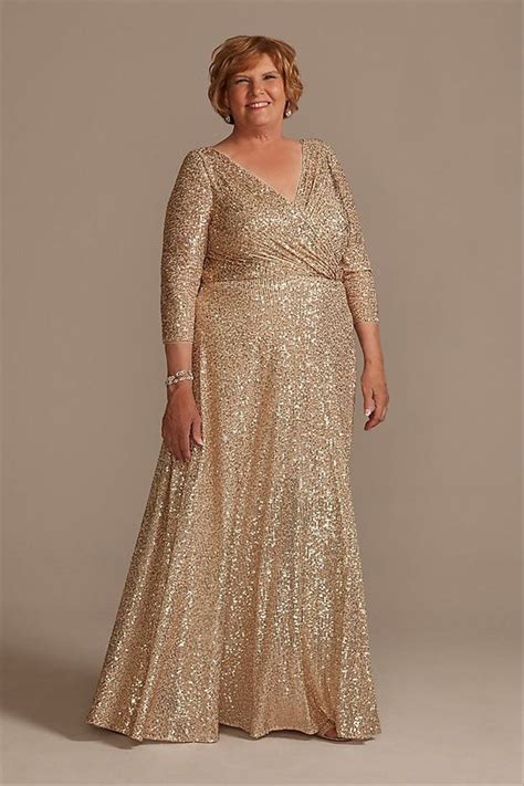 A Woman In A Gold Dress Posing For The Camera