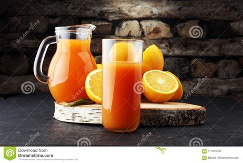 Glass Jar Of Fresh Orange Juice With Fresh Fruits On Dark Table Stock