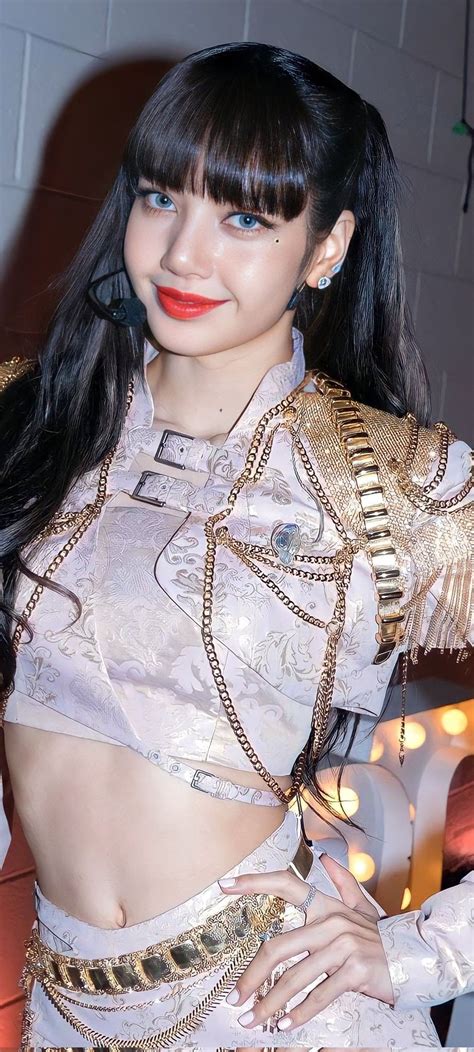 A Woman With Long Black Hair Wearing A White And Gold Outfit