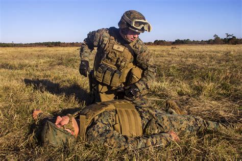 Marine Corps Lance Cpl Sean Curtis Kneeling Assesses A Simulated