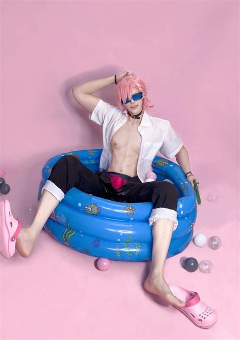 A Man With Pink Hair Sitting On Top Of An Inflatable Pool Floater