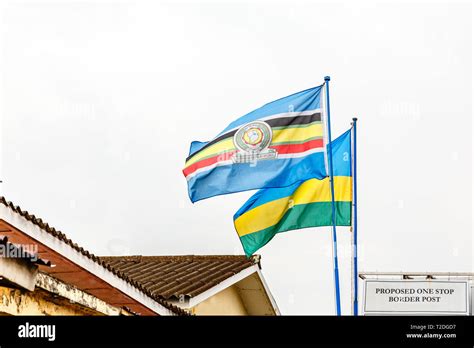 East African Community and Rwandan flags on the border between Rwanda and Democratic republic of ...