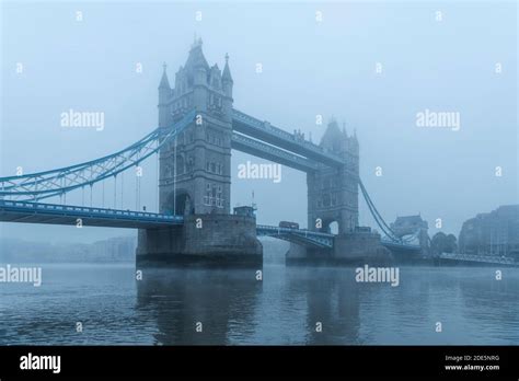 Tower Bridge And River Thames In Foggy And Misty Blue Atmospheric And