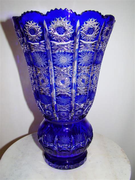 A Blue Vase Sitting On Top Of A White Table