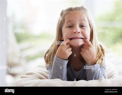 I Made You Look A Young Girl Making Funny Faces At Home Stock Photo