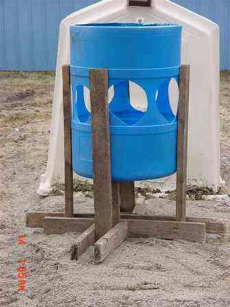 A Large Blue Barrel Sitting On Top Of A Wooden Stand